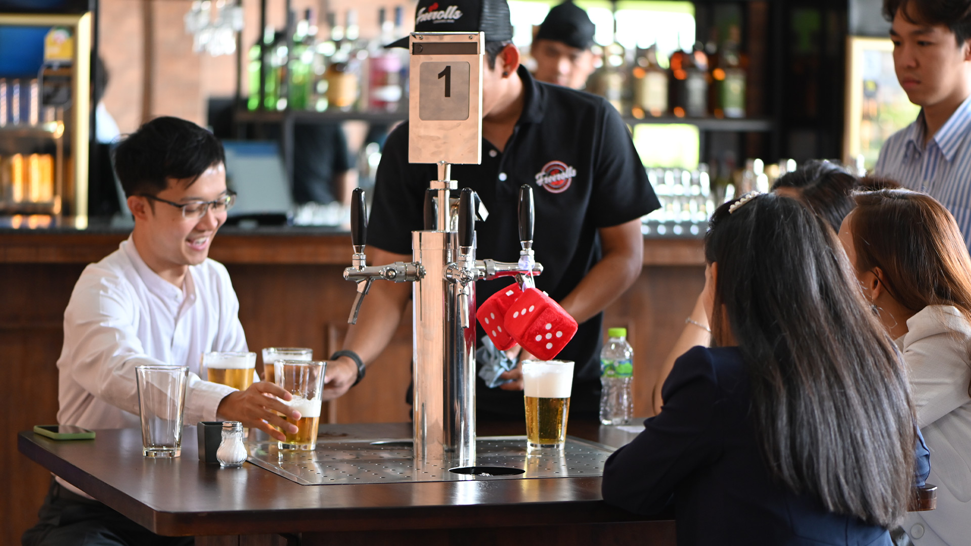 Guests at the self-pour beer taps